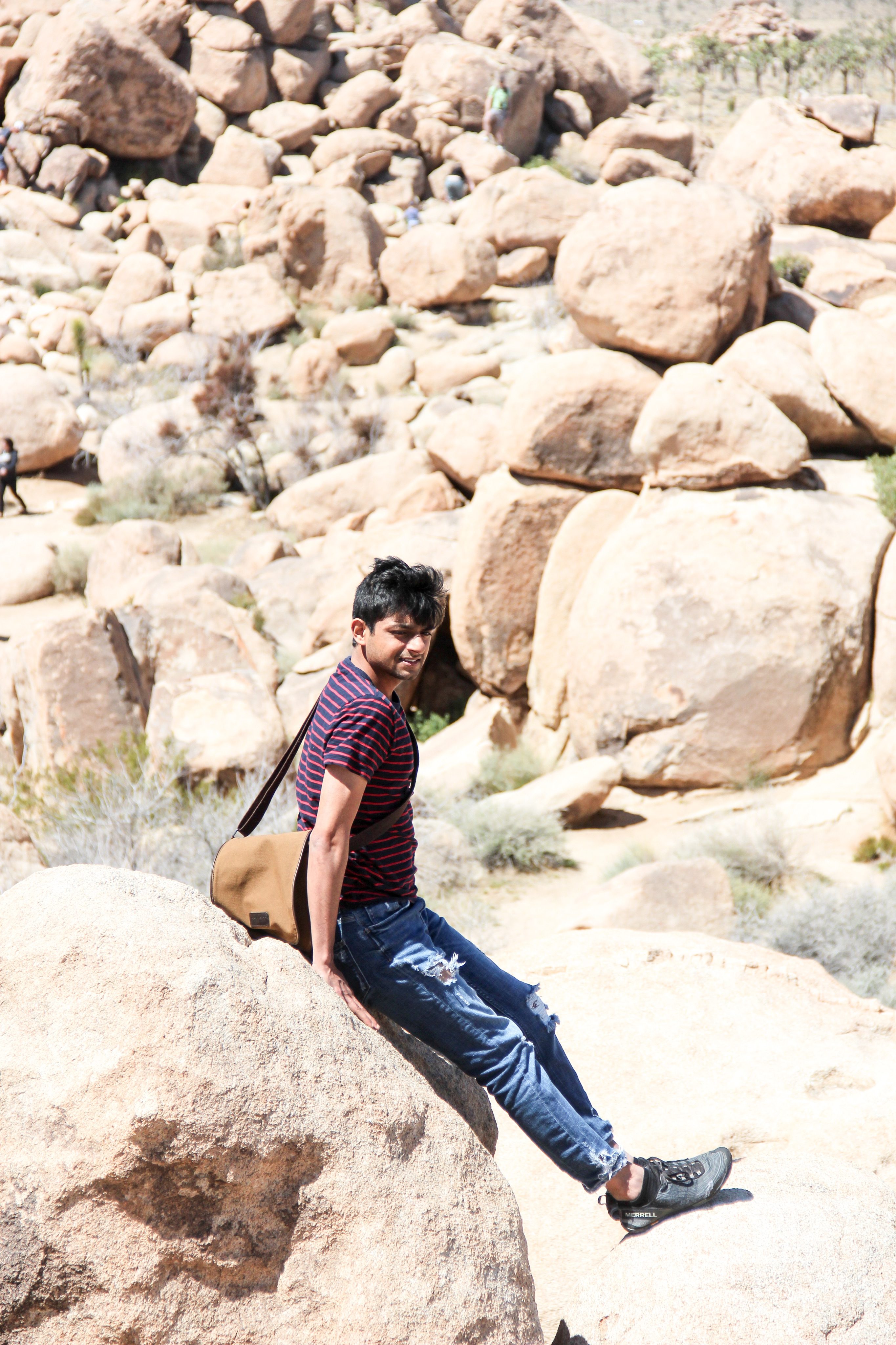 Picture of Akshay Cadambi among rocks in Joshua Tree, CA.